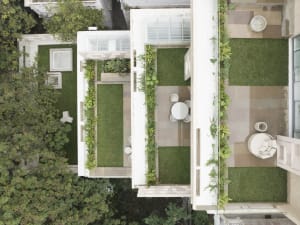Modern residential patio featuring concrete and green turf surfaces