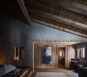 Industrial-style residential interior with wood materials and vaulted ceiling.