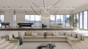 Modern living room with neutral tones and large windows.