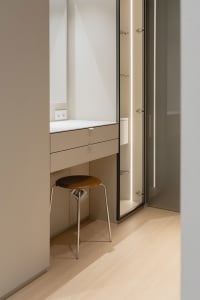 A minimalist bathroom featuring glass panels, modern design, and a sleek, uncluttered atmosphere.