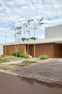 Modern residential exterior featuring sandstone and cement materials.