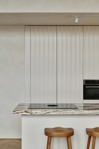 Modern kitchen interior featuring a marble countertop detail.