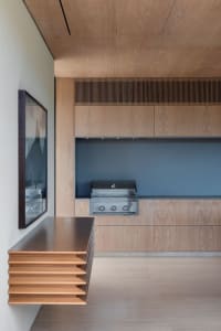 Modern minimalist kitchen with wooden finishes and sleek design.