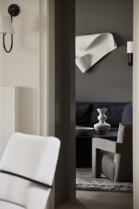 Modern living room featuring a textured fabric sofa and minimalist decor.