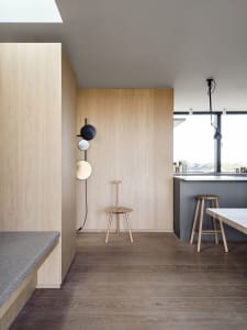 A modern interior design featuring wooden furniture and sleek, minimalist aesthetics.