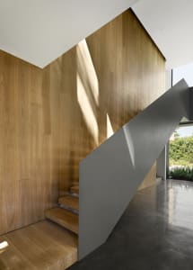 Modern industrial interior design featuring wooden stairs and walls