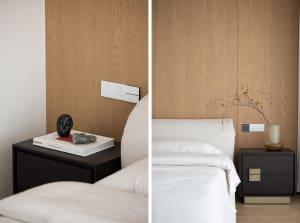 A modern bedroom with clear view of the bed and bedside table.