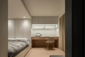 Modern neutral-toned bedroom interior design with concrete furniture and minimalistic decor.