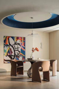 Modern dining room featuring marble table and upholstered seating