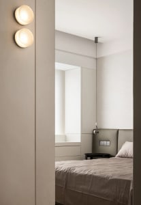 Minimalist bedroom with neutral materials and a bed.