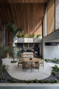 Modern residential interior featuring a combination of wood, concrete, and stone materials.
