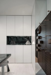 An industrial-style storage unit featuring metal finishes and a marble countertop.