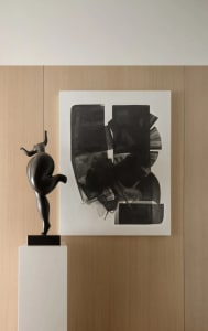 A black and white abstract painting featuring geometric shapes and a geometric sculpture on a pedestal.