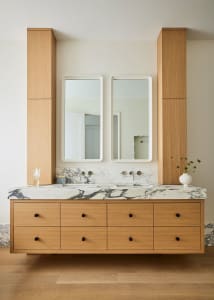 Modern bathroom with wood vanity and marble countertop and floors