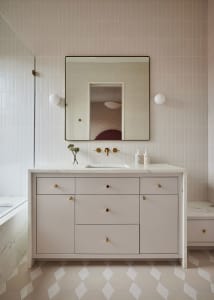Modern bathroom interior featuring a white cabinet, minimalist design, and concrete detailing.