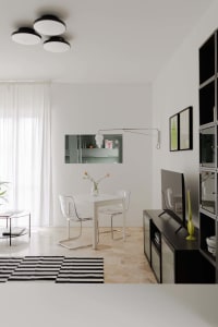 Modern dining room featuring a white dining table with two transparent plastic chairs, a black and white striped rug, and a w