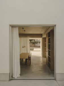 A minimalistic interior design featuring concrete and wooden elements.