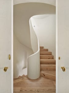 A modern staircase featuring a combination of concrete and wooden elements.