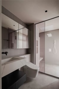 A modern minimalist bathroom featuring marble finishes and contemporary design elements.