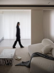 A modern residential sofa upholstered in neutral textiles