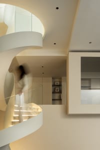 Modern staircase with glass railing and marble steps