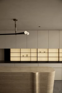 Modern kitchen with contemporary open shelves and a sleek, curved wooden island.