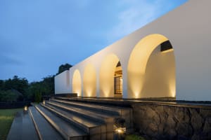 Modern architectural design featuring concrete archways lit from within.