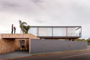 A modern building entrance with concrete walls and glass panels.