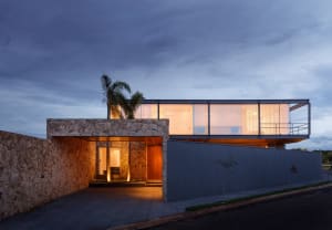 Modern residential architecture featuring glass and stone materials.