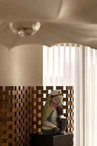 Contemporary abstract wooden sculpture with vibrant colors and intricate design.
