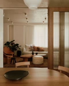 A modern living room featuring wooden furniture and soft lighting.