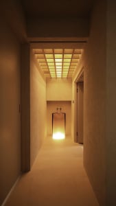 Modern concrete bathroom with a minimalist design and illuminated sink.