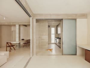 A minimalist living space featuring concrete walls and floors.