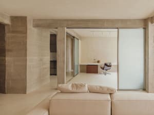 A modern office space featuring exposed concrete walls and a minimalist design.