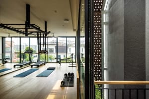 A modern workout room with wooden flooring and minimalistic design elements.