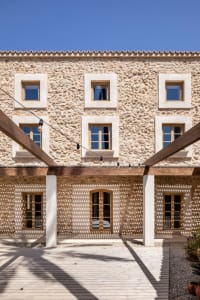 A stone building facade with wooden beams and blue sky