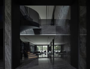 Modern interior design featuring marble materials and elegant black accents.