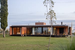 A modern house with brick and large glass windows.
