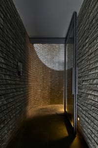 A curved brick wall hallway