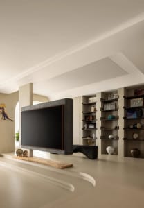 Modern living room featuring concrete walls and a wooden bench