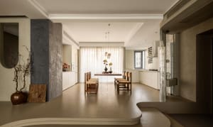 A modern residential dining space with neutral-toned materials.