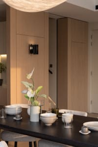 A well-lit, modern dining room with wooden walls and ceramic tableware.