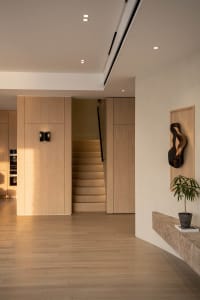 Modern interior design featuring a minimalist wooden hallway with sleek lines and warm, natural wood tones.