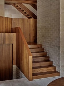 Modern, industrial-style stairs crafted from dark wood, featuring a minimalist design and geometric steps.