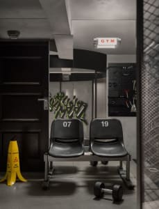 Gym locker room with metal seats and graffiti artwork