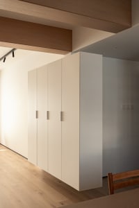 Modern minimalist cabinet with white painted surface and sleek, minimalistic design.