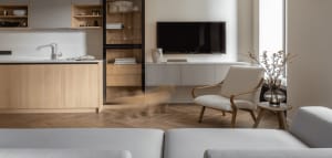 Modern living space featuring a wooden floor, white furniture, and minimalist decor.