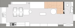 A modern open-concept living space with neutral-colored walls and a staircase in the background.