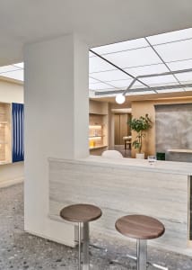 Modern industrial-style coffee shop bar counter with stools and minimalist aesthetic