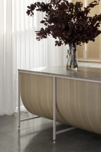 A modern, industrial-style metal desk with a marble top placed in an office setting.